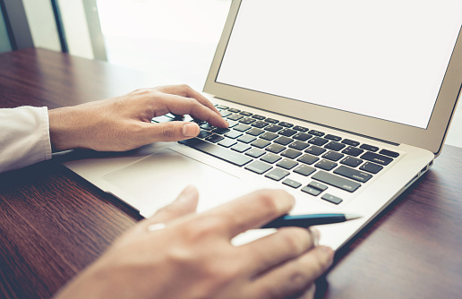 Young businessman multitasking using laptop.marketing planning
